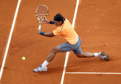 Rafael Nadal slides into a backhand in Monte Carlo