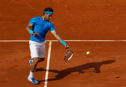 Rafael Nadal of Spain hits a forehand during the men's singles round two match between Rafael Nadal of Spain and Pablo Andujar of Spain on day five of the French Open at Roland Garros on May 26, 2011 in Paris, France.  (Photo by Matthew Stockman/Getty Images)