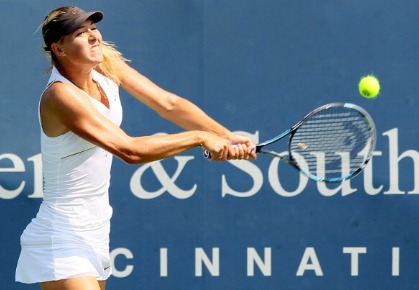 Maria Sharapova of Russia returns a shot to Samantha Stosur of Australia during the Western & Southern Open at the Lindner Family Tennis Center on August 19, 2011 in Mason, Ohio.  (Photo by Elsa/Getty Images)