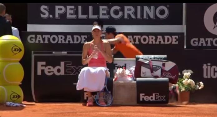 Maria Sharapova Sits in Chair at Changeover While Ballkid Trips over His Own Feet Behind Her 